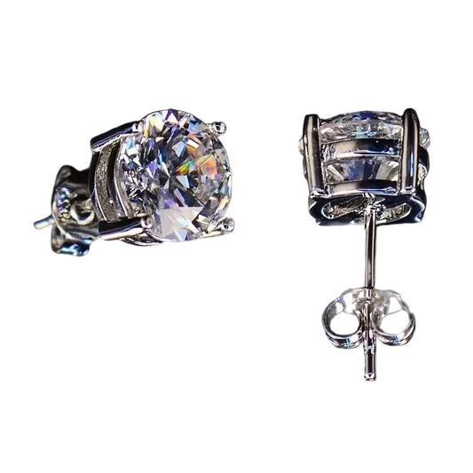 Pair of diamond stud earrings on a dark background